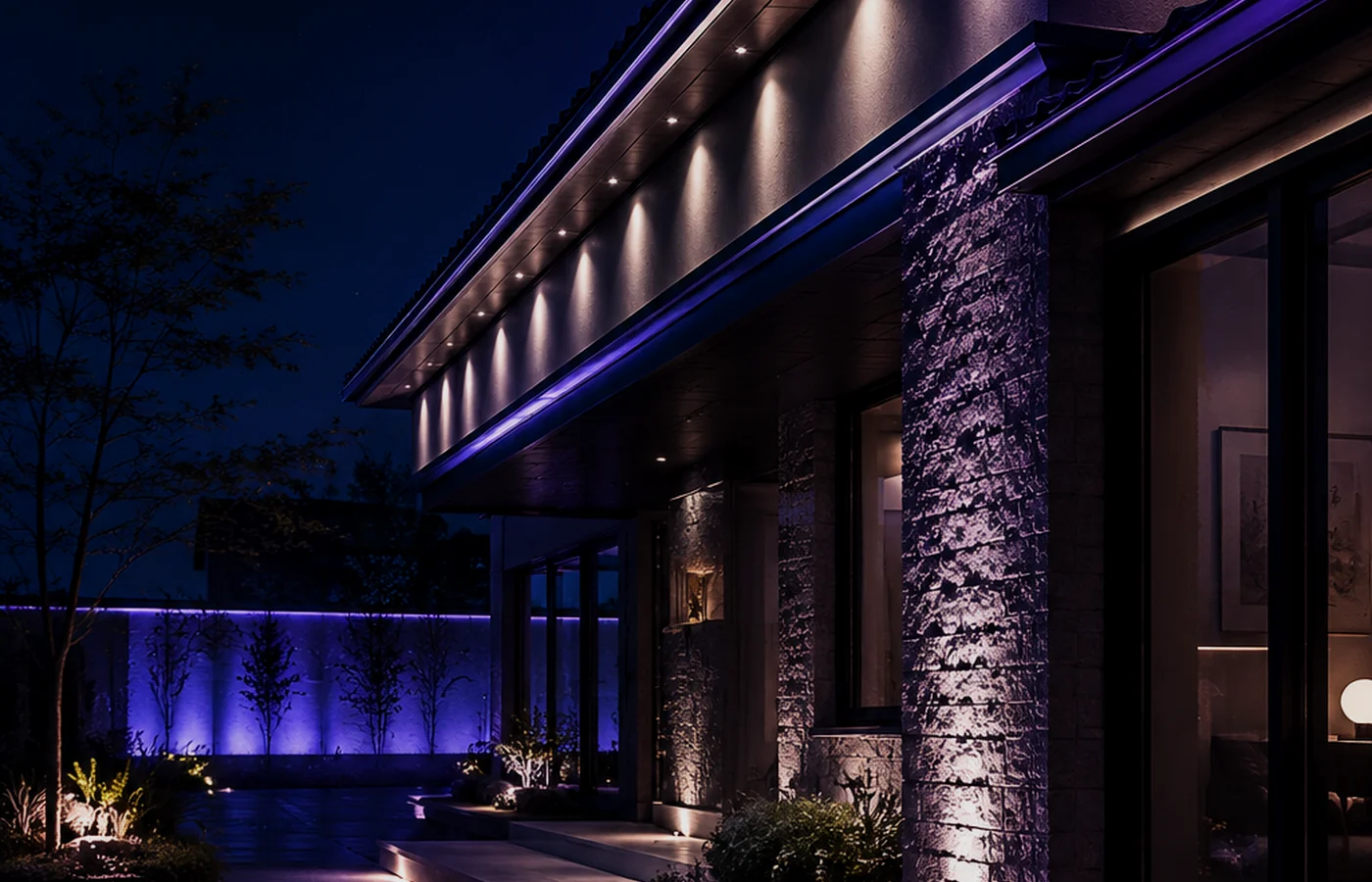 Purple-toned LED accent lighting along a building eave and courtyard at night.
